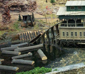 Mill logs on pond at a mirror image, scratch built copy of the Master Creations Coon Gap Sawmill